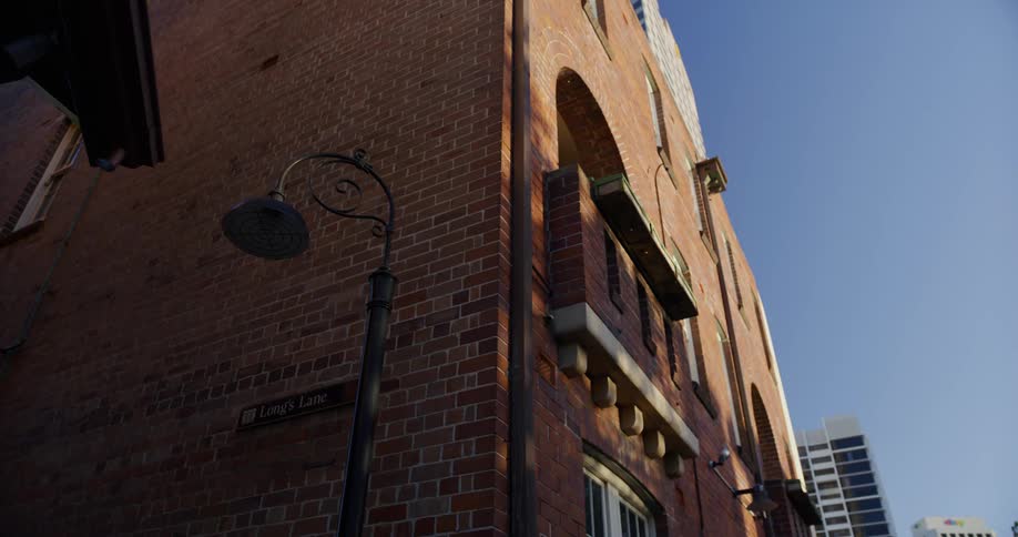 A corner city building made of red brick