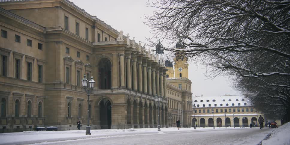 A large old building its entrance decorated with many columns and arches