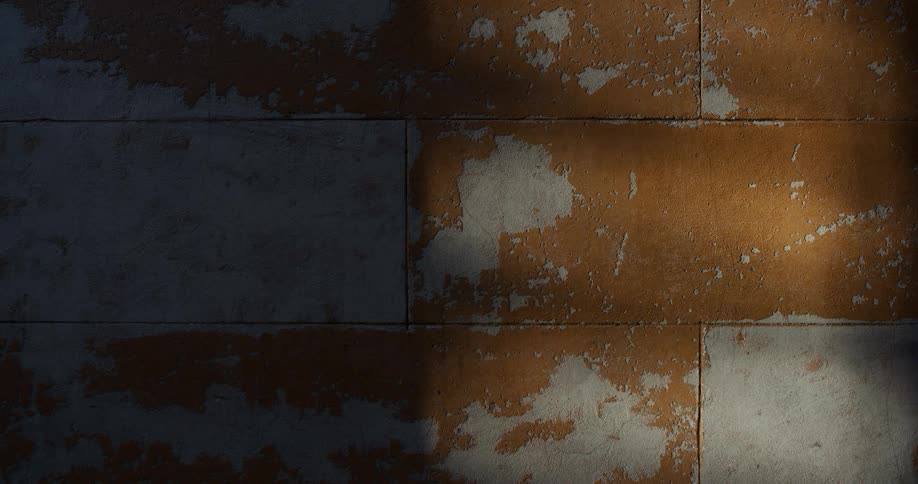 Weathered wall with peeling paint and contrasting light and shadow