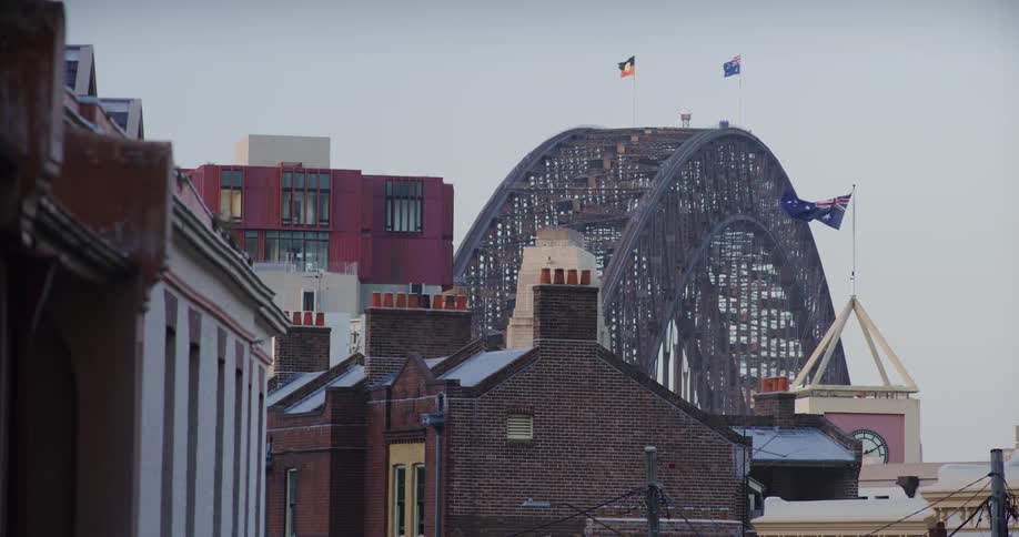 The wind blows the flags on the bridge