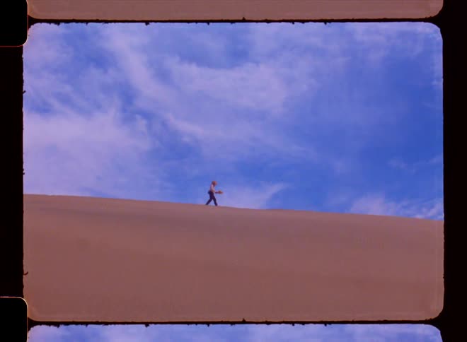 A person is walking in the desert