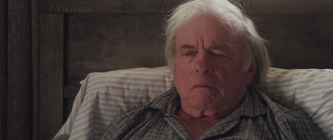 A slightly angry looking old man speaks