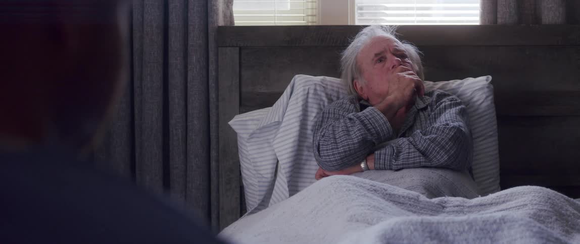 A clip of an old man on the bed