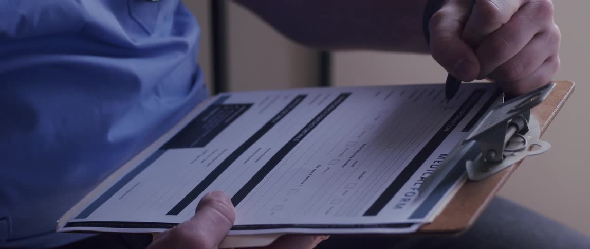 A clip of a person writing on a document