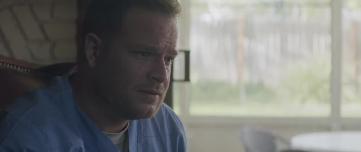 Doctor sitting indoors talking