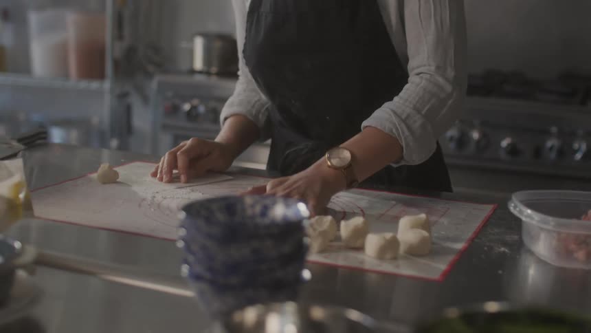 A woman prepares food in a restaurant