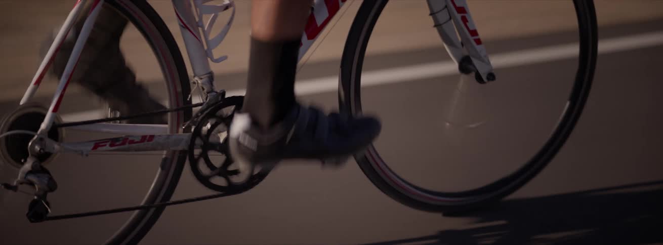 A person cycling down a road