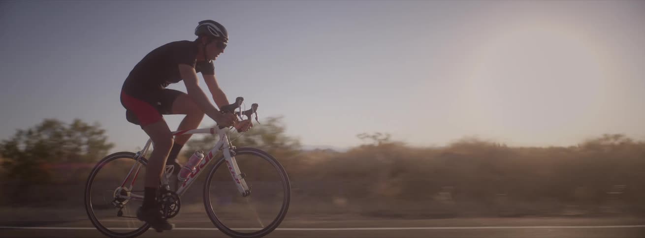 A man rides a bicycle on a road