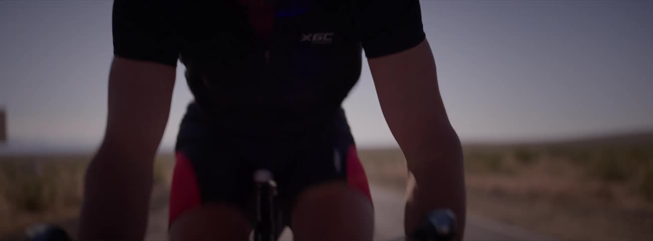 Man cyclist cyclist cycling on a road and a natural environment