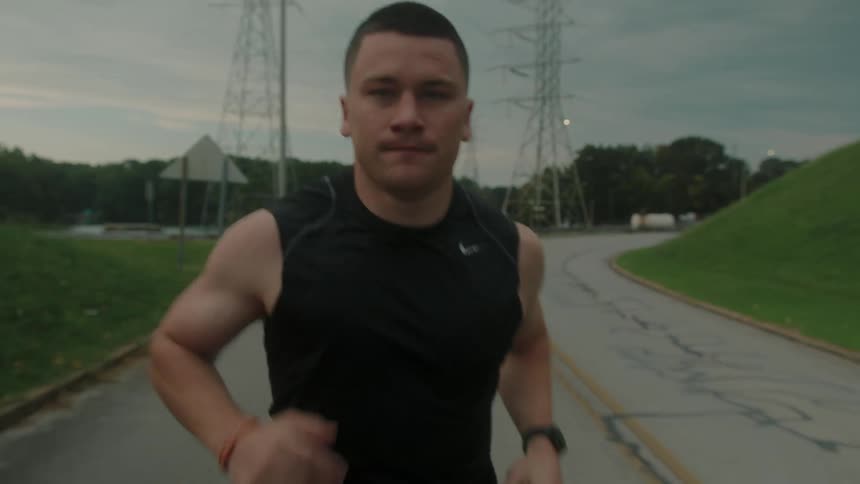 Concentrated man running through the city streets on a morning