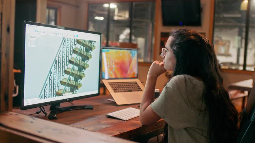 A designer working on a staircase on a computer