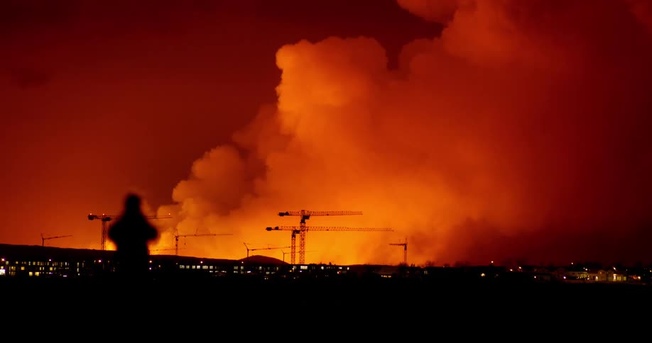 Icelandic person stops to take picture of volcanic eruption