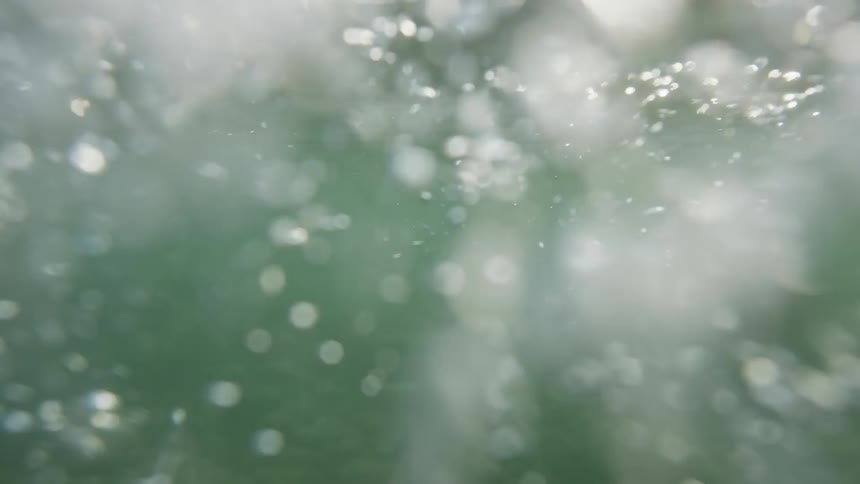 A hand sweeps through water