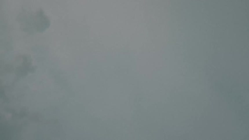 Upward view on a cloudy day with a lapse of a person running past