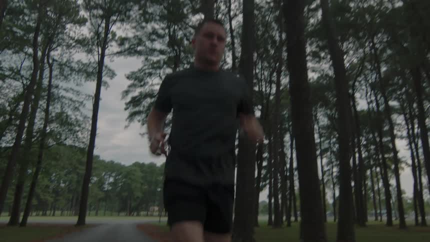 A man is running through the woods