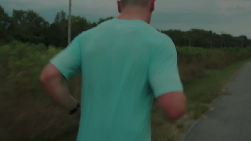 A man jogging on a rural road