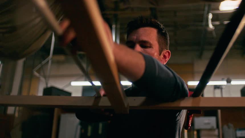 Man assembling a structure in a workshop