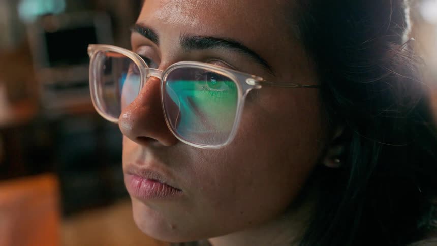 Portrait of a young woman wearing prescription glasses while concentrating