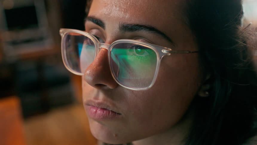 Portrait of a woman with prescription glasses concentrated reading