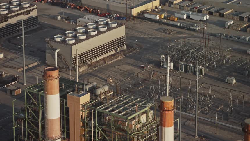 A factory complex including smoke stacks freight transportation and warehouses
