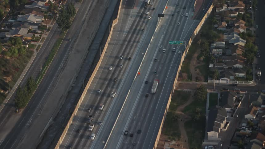 Traffic moves down an elevated highway in the suburbs