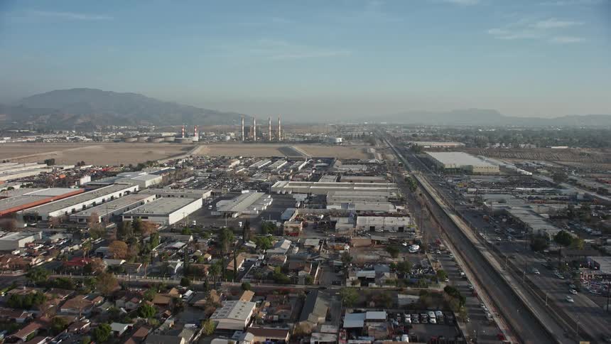 An industrial area of a city near a smaller residential and business center