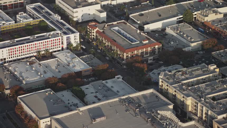 Aerial panorama of urban and commercial buildings with streets with vehicle traffic