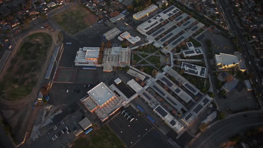 Aerial panorama of a recreation center on the side of a highway through the city