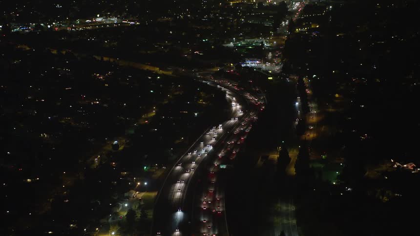 Panorama of a highway with vehicle traffic at night