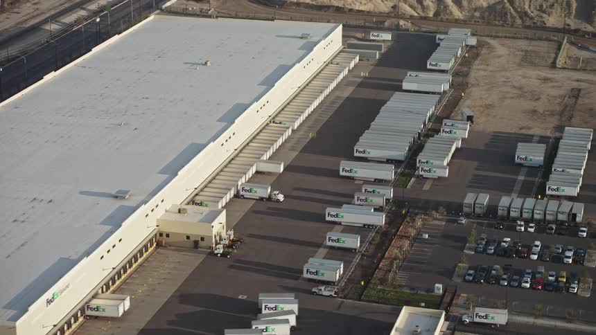 Aerial panorama of a logistics center with trucks and containers in a parking lot