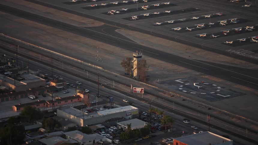 Aerial panorama of a conning tower next to a runway at an airport