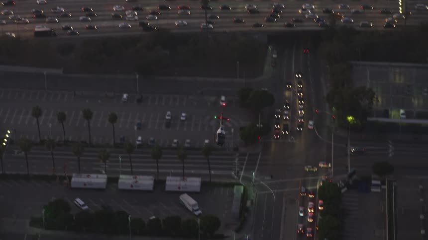 The helicopter flies over the city