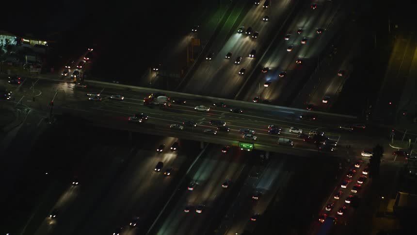 A night aerial clip of a high way full of cars