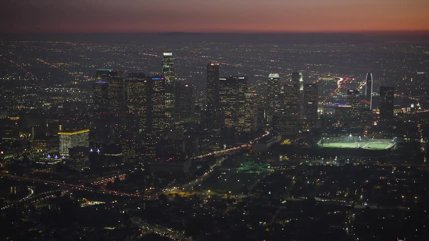 Heavy traffic runs through the city at sunset