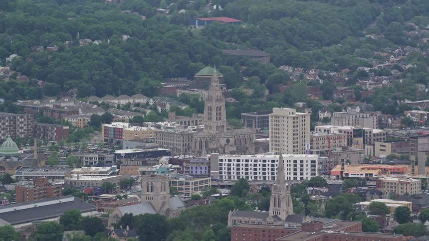 Aerial panorama of an urban city with a cathedral on hills in with vegetation