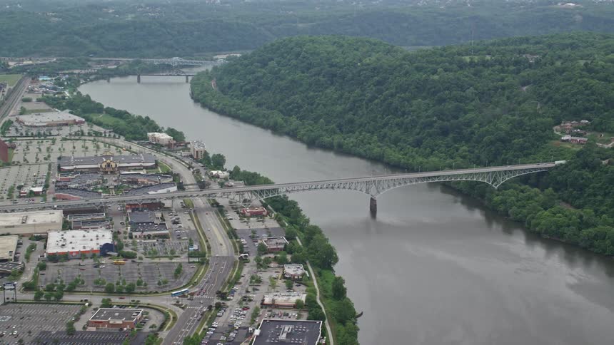 A bridge connects a suburb and the city across the river from each other