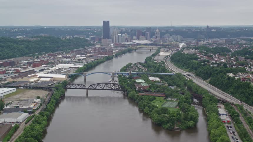 Aerial panorama of a metropolis with skyscrapers and a side canal with bridges connecting the cities