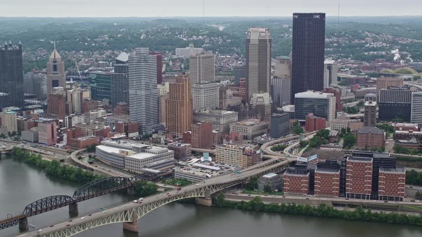 Panorama of a metropolis with a skyscraper on the edge of a lake with interconnecting bridges