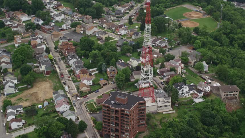A large antenna towers over nearby neighborhoods