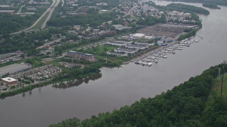 A marina on a river next to a city