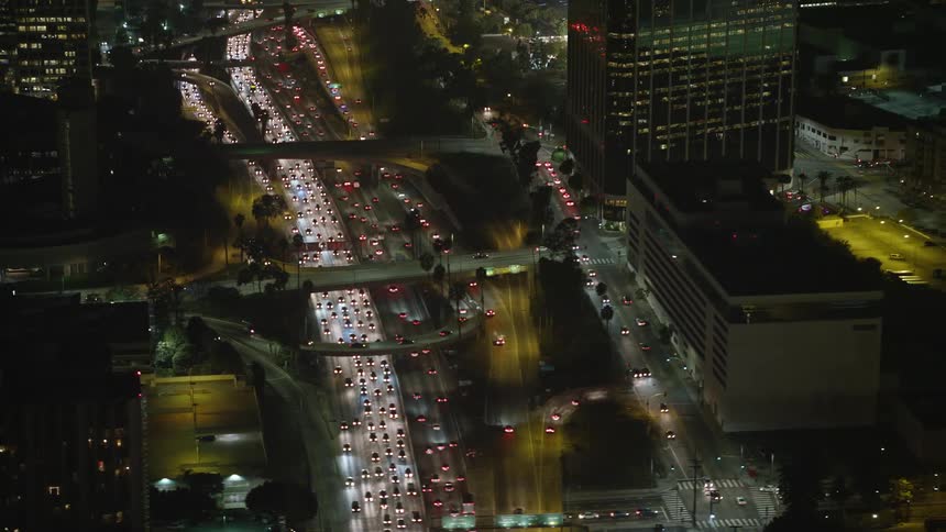 Aeria view of city streets bustling with vehicles at night