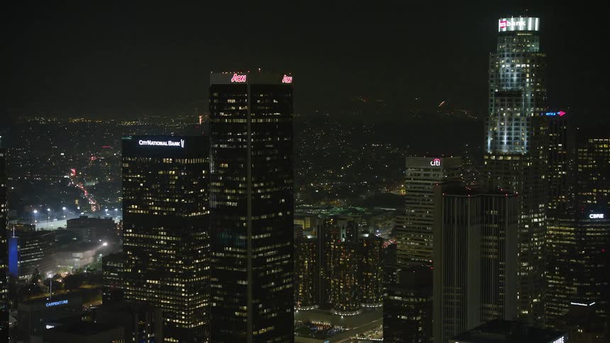 Panorama of large buildings and skyscrapers illuminated at night in a metropolis