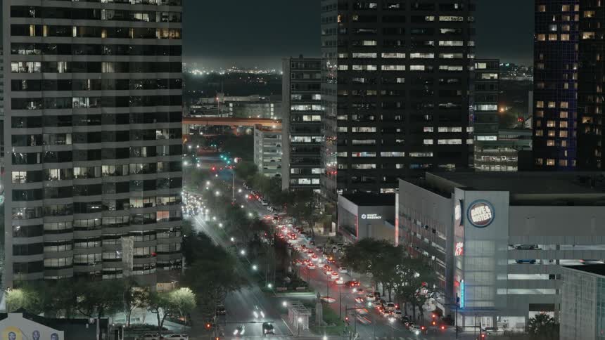 Intense vehicle traffic on a highway in a metropolis at night in timelapse