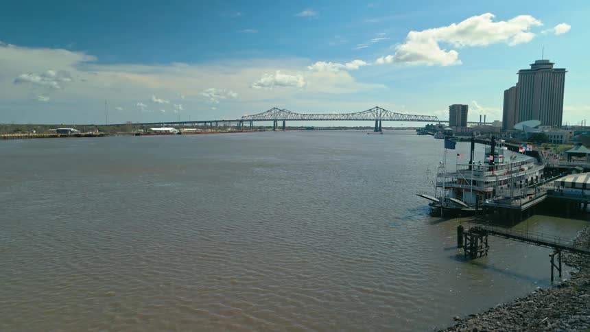 Aerial panorama of the sea with a bridge connecting a metropolitan city during a blue sky day with clouds
