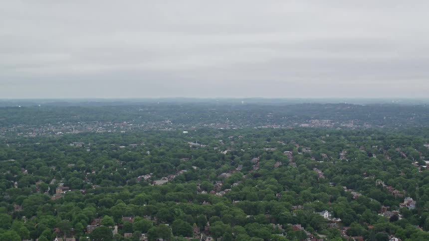 A sprawling community contains a large number of green trees