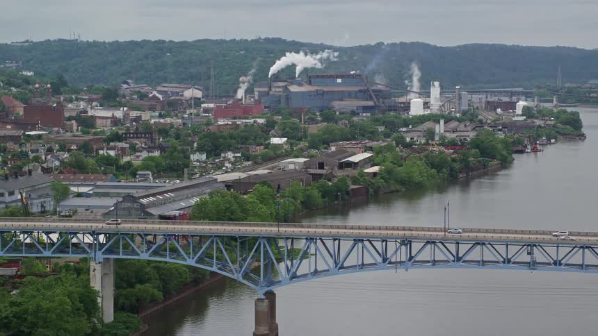 Traffic drives over the bridges near the factory