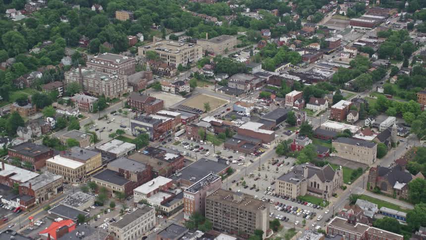 A sprawling residential area is filled with roads trees and buildings