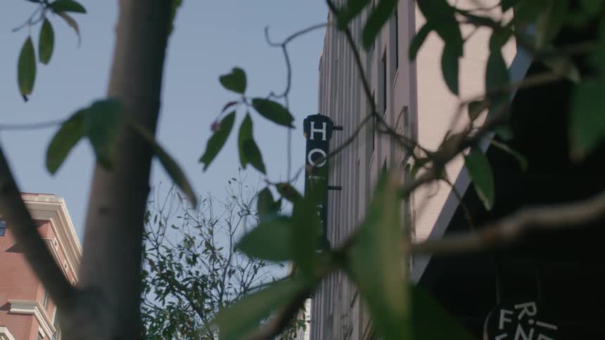 A shot of a hotel sign on a building