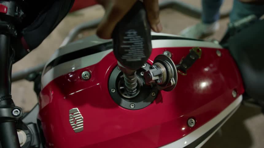 Closeup of a motorcycles fuel tank being filled