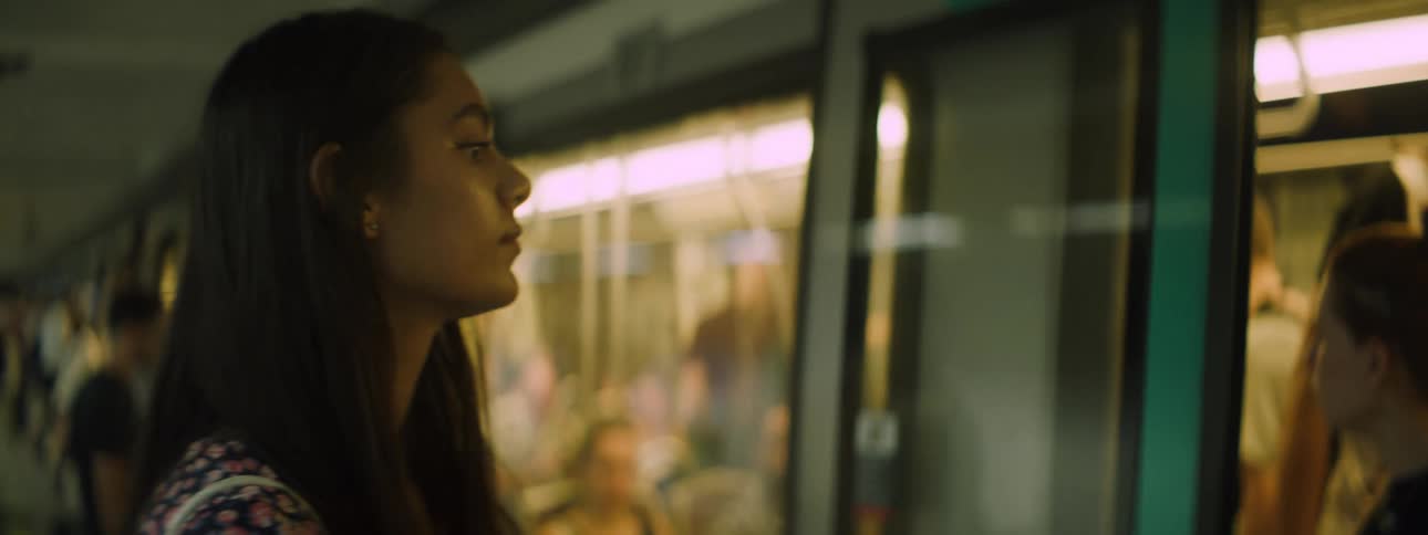 A woman is waiting and then enters a subway